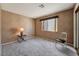Bedroom with neutral paint, carpeted floors, and a classic chair at 7608 Painted Dunes Dr, Las Vegas, NV 89149