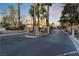 Community entrance gate with stone pillars and manicured landscaping shows secured entry at 7608 Painted Dunes Dr, Las Vegas, NV 89149