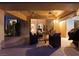 Covered patio featuring a ceiling fan, comfortable outdoor seating, and a view of the lush backyard at 7608 Painted Dunes Dr, Las Vegas, NV 89149