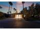Home exterior with a three-car garage, mature trees, and a spacious driveway, perfect for Gathering living at 7608 Painted Dunes Dr, Las Vegas, NV 89149