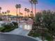 Charming single-story home featuring mature landscaping, a driveway, and a two-car garage against a beautiful sunset at 7608 Painted Dunes Dr, Las Vegas, NV 89149