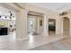 Elegant foyer with tile floors, decorative pillars, and a view of the dining and living areas at 7608 Painted Dunes Dr, Las Vegas, NV 89149