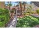 Charming front exterior with lush landscaping, a well-manicured lawn, and a welcoming entrance at 7608 Painted Dunes Dr, Las Vegas, NV 89149