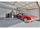 Garage featuring an epoxy floor and a red classic car at 7608 Painted Dunes Dr, Las Vegas, NV 89149