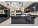 Modern kitchen with sleek black cabinetry, stainless steel appliances, and a large island at 7608 Painted Dunes Dr, Las Vegas, NV 89149