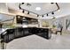 Sleek kitchen with black cabinets, granite countertops, and modern appliances, offering a stylish cooking space at 7608 Painted Dunes Dr, Las Vegas, NV 89149