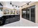 Spacious kitchen with black cabinets, granite countertops, and modern appliances, offering a stylish cooking space at 7608 Painted Dunes Dr, Las Vegas, NV 89149