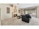 Bright living room featuring a cozy fireplace and sliding doors to the outdoor patio area at 7608 Painted Dunes Dr, Las Vegas, NV 89149