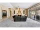 Open-concept living room with a fireplace, and sliding glass doors at 7608 Painted Dunes Dr, Las Vegas, NV 89149