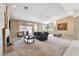 Spacious living room with fireplace, plush seating, and view of the outdoor living area at 7608 Painted Dunes Dr, Las Vegas, NV 89149