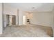 Open living area with neutral carpet and fireplace at 7608 Painted Dunes Dr, Las Vegas, NV 89149
