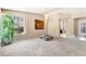 Spacious living area with ample natural light, chandelier, and neutral decor throughout at 7608 Painted Dunes Dr, Las Vegas, NV 89149