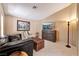 The living room has neutral walls, tile floors, and stylish furniture at 7608 Painted Dunes Dr, Las Vegas, NV 89149