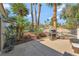 Outdoor patio featuring a built-in grill and lush greenery, perfect for entertaining guests at 7608 Painted Dunes Dr, Las Vegas, NV 89149