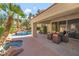 Beautiful outdoor patio with pool, spa, and comfortable seating area perfect for relaxation at 7608 Painted Dunes Dr, Las Vegas, NV 89149