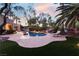 Inviting outdoor pool featuring a rock waterfall, lounge chair, and beautifully landscaped backyard at 7608 Painted Dunes Dr, Las Vegas, NV 89149