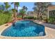 Sparkling pool featuring stone accents and lush tropical landscaping for a backyard paradise at 7608 Painted Dunes Dr, Las Vegas, NV 89149