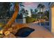 Luxury pool and spa with a rock waterfall feature amidst lush tropical landscaping perfect for entertaining at 7608 Painted Dunes Dr, Las Vegas, NV 89149