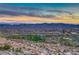 Scenic aerial view of a community with a park, walking trails and mountain views at 7731 Ornamento Way, Las Vegas, NV 89179