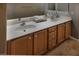 Bright bathroom featuring a double vanity with wooden cabinets and modern fixtures at 7731 Ornamento Way, Las Vegas, NV 89179
