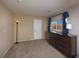 Bedroom showcasing a dresser, window, and neutral carpet at 7731 Ornamento Way, Las Vegas, NV 89179