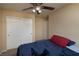 Cozy bedroom with ceiling fan, closet, and comfortable bed creates a relaxing atmosphere at 7731 Ornamento Way, Las Vegas, NV 89179