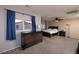 Comfortable bedroom with neutral carpet, a ceiling fan and a dresser at 7731 Ornamento Way, Las Vegas, NV 89179