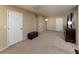 Large bonus room featuring neutral carpet and multiple closets at 7731 Ornamento Way, Las Vegas, NV 89179