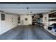 Open garage with lots of storage, shows the cement floor and open door at 7731 Ornamento Way, Las Vegas, NV 89179
