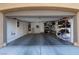 A wide angle shot of the garage, full of shelves, bins and a water heater at 7731 Ornamento Way, Las Vegas, NV 89179