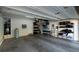 Spacious garage interior equipped with overhead lighting and ample storage shelving for organization at 7731 Ornamento Way, Las Vegas, NV 89179