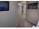 Hallway featuring neutral walls, carpeted flooring, and framed art, connecting different areas of the home at 7731 Ornamento Way, Las Vegas, NV 89179