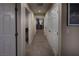 Hallway view with neutral walls and carpet, showcasing doorways and closets at 7731 Ornamento Way, Las Vegas, NV 89179