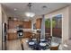 Eat-in kitchen featuring stainless steel appliances, granite countertops, and sliding glass door to patio at 7731 Ornamento Way, Las Vegas, NV 89179