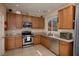 Charming kitchen with stainless steel appliances and oak cabinets at 7731 Ornamento Way, Las Vegas, NV 89179