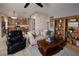 Open living space featuring a sofa, chair, and wooden bookshelf adjacent to the kitchen at 7731 Ornamento Way, Las Vegas, NV 89179