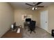 Office space featuring neutral walls, carpet flooring, ceiling fan, and a window for natural light at 7731 Ornamento Way, Las Vegas, NV 89179