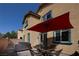 Cozy patio with table, chairs, grill and shade umbrella for outdoor enjoyment at 7731 Ornamento Way, Las Vegas, NV 89179