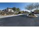 Neighborhood street view showcases well-maintained landscaping, sidewalks, and residential buildings at 7731 Ornamento Way, Las Vegas, NV 89179