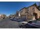 A street view of a two-story home with attached garage, landscaping, and nearby similar residences at 7731 Ornamento Way, Las Vegas, NV 89179