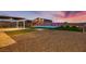 Expansive backyard featuring a pool, putting green, patio and xeriscaping at 7966 W Ford Ave, Las Vegas, NV 89113