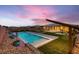 Beautiful backyard featuring a pool, manicured lawn, stylish hardscape and custom planters at 7966 W Ford Ave, Las Vegas, NV 89113