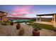 Backyard featuring a pool, lush landscaping, patio and putting green at 7966 W Ford Ave, Las Vegas, NV 89113