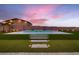 Backyard view featuring a pool, manicured lawn, stylish pavers and landscape lighting at 7966 W Ford Ave, Las Vegas, NV 89113