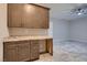 Elegant bar area featuring custom cabinets, granite countertops, and a view to the connected room at 7966 W Ford Ave, Las Vegas, NV 89113