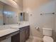 Bathroom features a large mirror, modern vanity with a marble countertop and under-mount sink at 7966 W Ford Ave, Las Vegas, NV 89113
