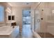 A luxurious bathroom featuring a soaking tub, a frameless glass shower, and sleek fixtures at 7966 W Ford Ave, Las Vegas, NV 89113