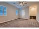 Inviting bedroom with a ceiling fan, carpet, plantation shuttered windows, and a cozy workspace at 7966 W Ford Ave, Las Vegas, NV 89113