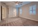 Expansive bedroom with adjoining bathroom and closet, featuring carpet and plantation shuttered windows at 7966 W Ford Ave, Las Vegas, NV 89113