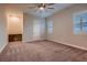 Cozy bedroom offering plush carpet, a built-in desk area, and natural light from shuttered windows at 7966 W Ford Ave, Las Vegas, NV 89113